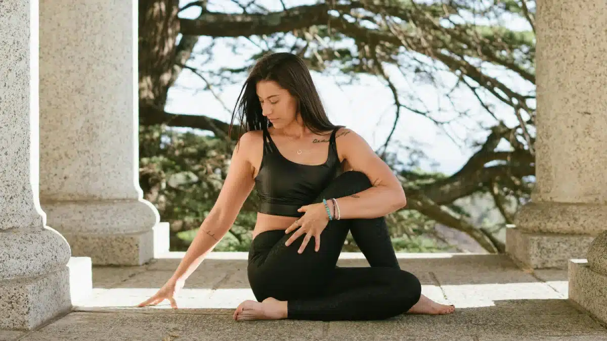 Woman in Black Tank Top and Black Leggings Sitting on Floor