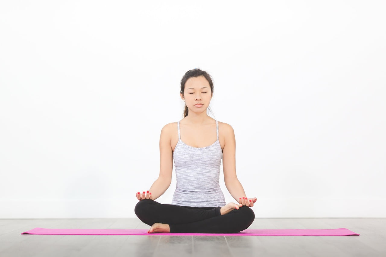 girl doing yoga with mat