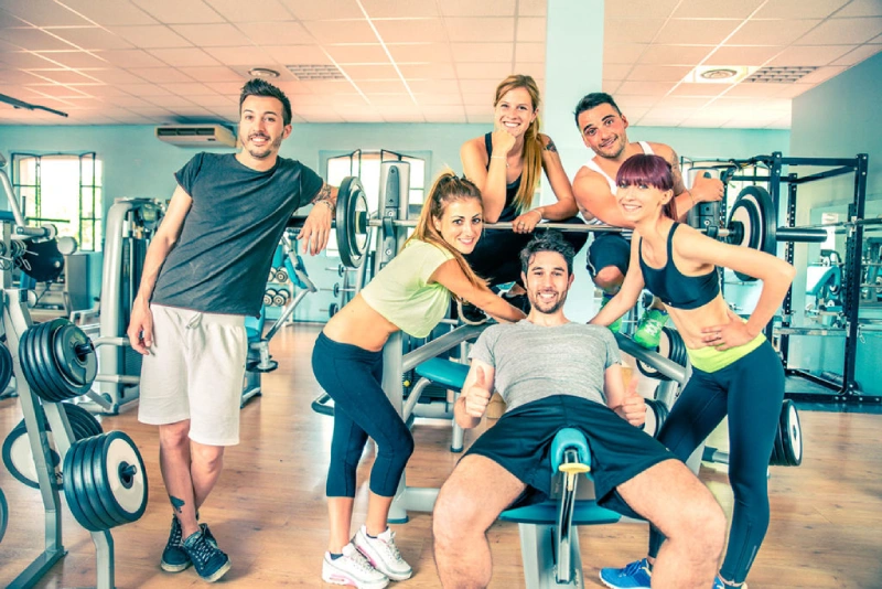 A happy family working out together at home using an exercise gym machine.