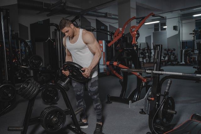 a man carrying a gym weight plates