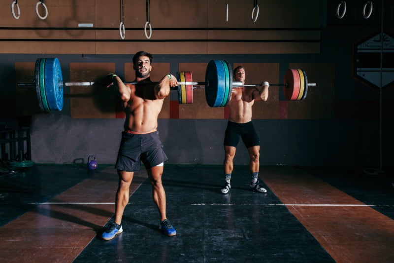 Two man doing gym weight training