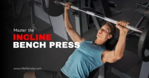 Man performing an incline bench press exercise in a gym.