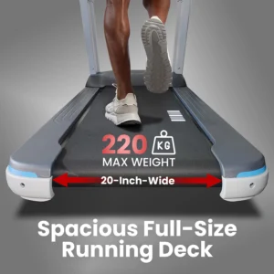 A person running on the spacious, 20-inch-wide running deck of a heavy-duty treadmill, highlighting its high 220 kg maximum user weight capacity.
