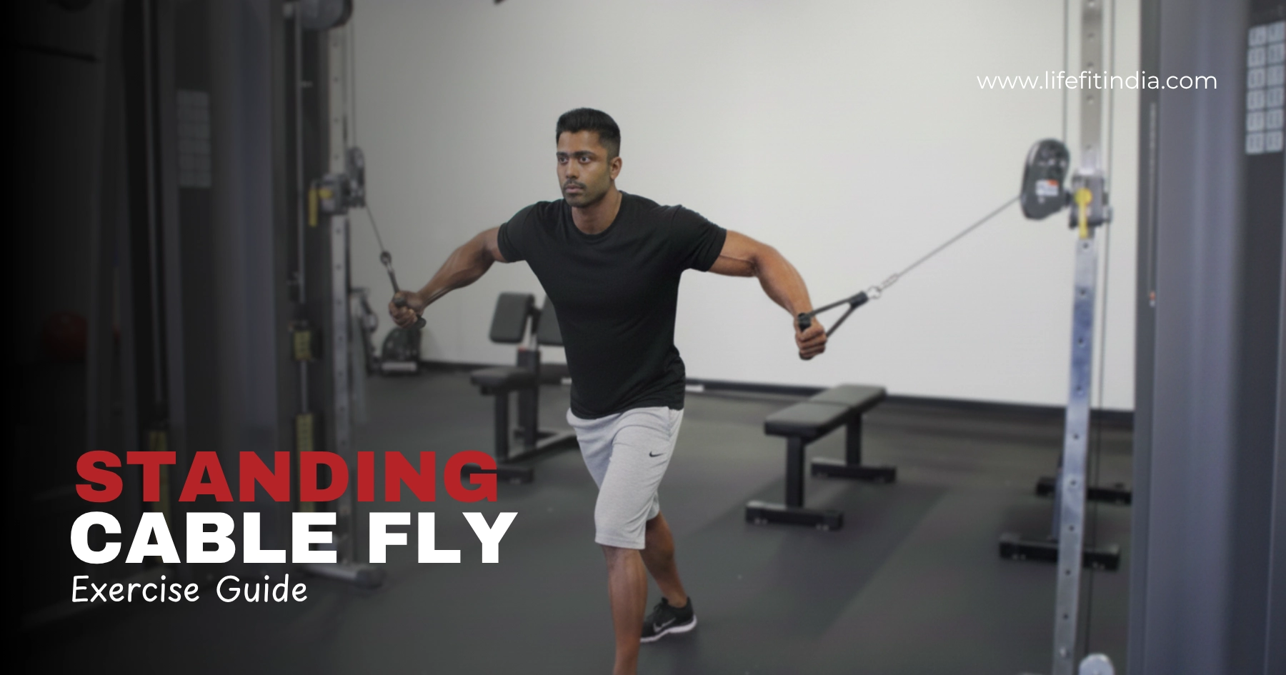 Male fitness athlete performing the Standing Cable Fly exercise using a dual pulley machine to build chest muscles inside a modern gym – Life Fit India guide.